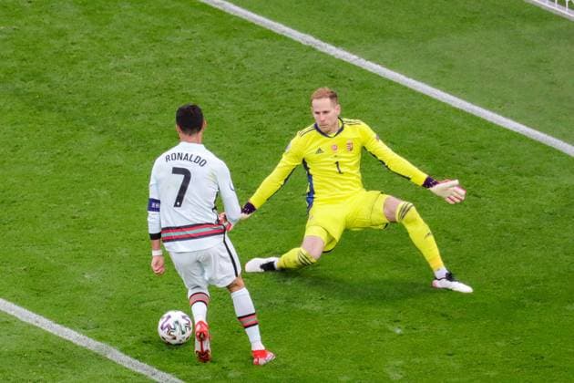 Budapest, Hungary, June 15h 2021: Cristiano Ronaldo (7 Portugal) scores another goal against Goalkeeper P? ter Gulacsi (Hungary) during the European Championship, EM, Europameisterschaft football match between Hungary and Portugal at Puskas Ar? na in Budagpest, Hungary. 