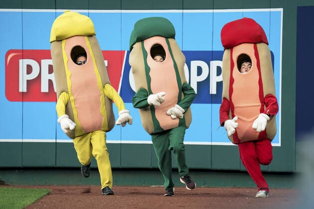 Fans run in the Hot Dog Derby in the third inning of the Kansas City Royals and the Boston Red Sox game at Kaufman Stadium in Kansas City, Missouri on Friday, June 18, 2021.  KCP20210618113 KYLExRIVAS