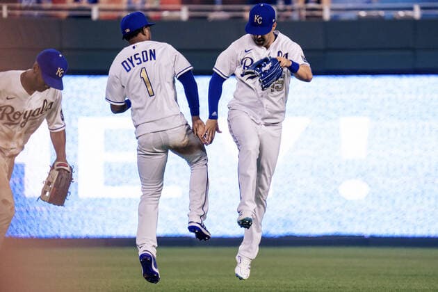 Kansas City Royals center fielder Jarrod Dyson (1) and right fielder Whit Merrifield (15) celebrate a victory over the Boston Red Sox at Kaufman Stadium in Kansas City, Missouri on Friday, June 18, 2021.  KCP20210618126 KYLExRIVAS