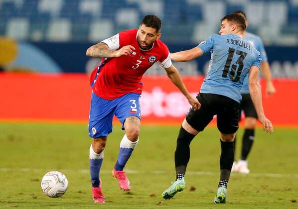 CUIABA, BRAZIL - JUNE 21: Guillermo Maripan of Chile competes for the ball with Giovanni Gonzalez of Uruguay ,during the match between Uruguay and Chile as part of Conmebol Copa America Brazil 2021 at Arena Pantanal on June 21, 2021 in Cuiaba, Brazil. SPO, SOC, ICH 