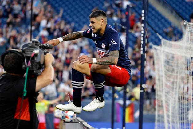 FOXBOROUGH, MA - JUNE 23: New England Revolution forward Gustavo Bou (7) jumps the barrier to celebrate his goal with the fans during a match between the New England Revolution and the New York Red Bulls on June 23, 2021 at Gillette Stadium in Foxborough, Massachusetts. (Photo by Fred Kfoury III Icon Sportswire) SOCCER: JUN 23 MLS, Fussball Herren, USA - New York Red Bulls at New England Revolution Icon482210623019