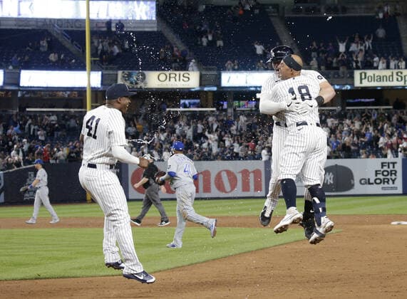 New York Yankees Luke Voit celebrates with Rougned Odor and Miguel Aguilar after hitting a walk off RBI single in the 9th inning against the Kansas City Royals at Yankee Stadium on Wednesday, June 23, 2021 in New York City. The Yankees defeated the Royals 6-5.  NYP20210623118 JOHNxANGELILLO