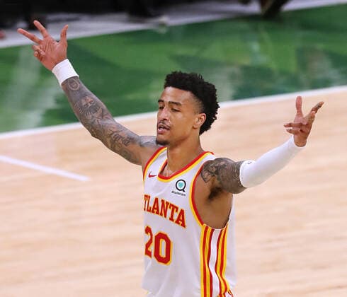 June 23, 2021, Milwaukee, WI, USA: The Atlanta Hawks John Collins reacts as teammate Trae Young converts a 3-pointer against the Milwaukee Bucks in Game 1 of the NBA, Basketball Herren, USA Eastern Conference Finals on Wednesday, June 23, 2021, at the Fiserv Forum in Milwaukee. The Hawks won, 116-113. Milwaukee USA - ZUMAm67_ 0122638637st Copyright: xCurtisxComptonx