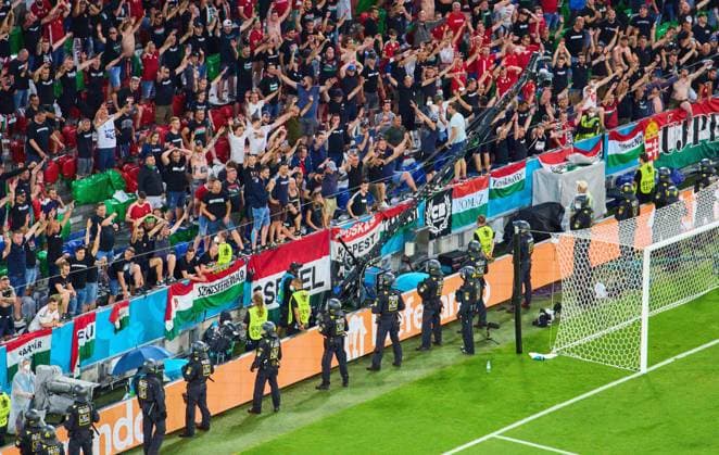 Hungarian fans and police officer in the Group F match GERMANY - HUNGARY 2-2 at the football UEFA European Championships 2020 in Season 2020 2021 on June 23, 2021 in Munich, Germany.
