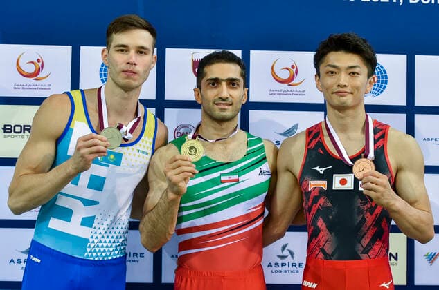 (210626) -- DOHA, June 26, 2021 -- Gold medalist Saeedreza Keikha (C) of Iran, silver medalist Nariman Kurbanov (L) of Kazakistan and bronze medalist Kameyama Kohei of Japan pose during the awarding ceremony for the Men s Pommel Horse Final at the 13th FIG Artistic Gymnastics World Cup in Doha, capital of Qatar, on June 25, 2021. (Photo by Xinhua) (SP)QATAR-DOHA-GYMNASTICS-WORLD CUP Nikku 