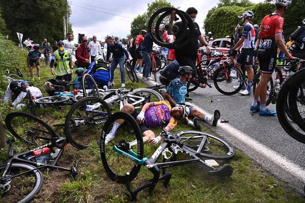 A rider of Alpecin-Fenix and French Bryan Coquard of BB Hotels P B KTM pictured after a fall during the first stage of the 108th edition of the Tour de France cycling race, 197,8km from Brest to Landerneau, France, . This year s Tour de France takes place from 26 June to 18 July 2021. POOLxANNE-CHRISTINExPOUJOULAT  x3019231x