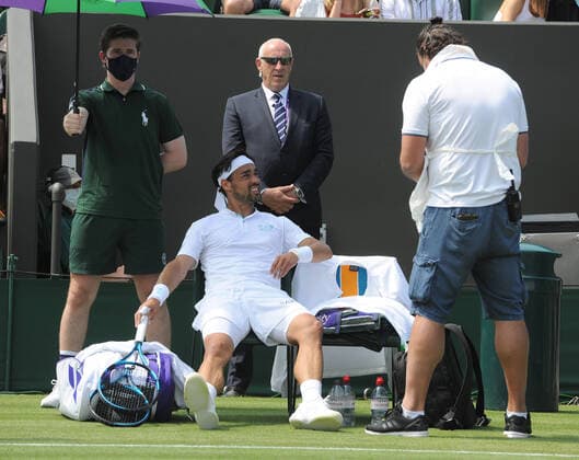 Tennis - 2021 All England Championships - Week One - Day Five (Friday) - Wimbledon Fabio Fognini v Andre Rublev Fabio Fognini of Italy in pain , waits for the physio 