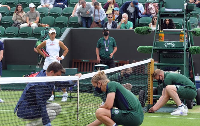 Tennis - 2021 All England Championships - Week One - Day Six (Saturday) - Wimbledon Ladies Singles Angelique Kerber v Aliaksandra Sasnovich Angelic Kerber of Germany waits for the net to go back up after the rain delay 