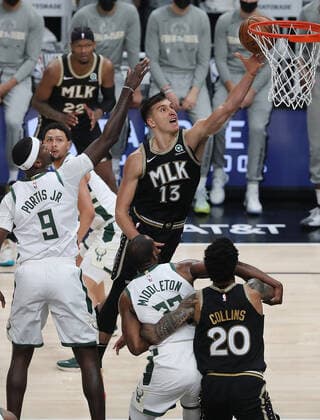 July 3, 2021, Atlanta, GA, USA: The Atlanta Hawks Bogdan Bogdanovic (13) goes to the basket for two past Milwaukee Bucks defender Bobby Portis (9) during the first quarter in Game 6 of the Eastern Conference Finals on Saturday, July 3, 2021, at State Farm Arena in Atlanta. The Bucks advanced, 118-107. Atlanta USA - ZUMAm67_ 0124090538st Copyright: xCurtisxComptonx