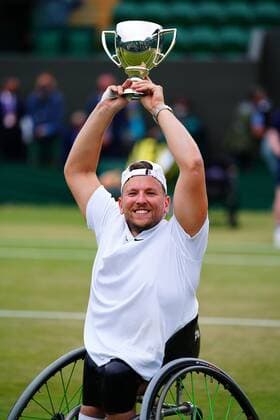Mandatory Credit: Photo by Javier Garcia Shutterstock (12203621be) Dylan Alcott celebrates with the trophy after victory in the Quad Wheelchair Singles final Wimbledon Tennis Championships, Day 12, The All England Lawn Tennis and Croquet Club, London, UK - 10 Jul 2021 Wimbledon Tennis Championships, Day 12, The All England Lawn Tennis and Croquet Club, London, UK - 10 Jul 2021  Copyright: xJavierxGarcia Shutterstockx 12203621be