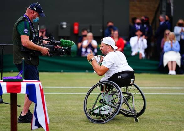 Mandatory Credit: Photo by Javier Garcia Shutterstock (12203621bh) Dylan Alcott celebrates with the trophy after victory in the Quad Wheelchair Singles final Wimbledon Tennis Championships, Day 12, The All England Lawn Tennis and Croquet Club, London, UK - 10 Jul 2021 Wimbledon Tennis Championships, Day 12, The All England Lawn Tennis and Croquet Club, London, UK - 10 Jul 2021  Copyright: xJavierxGarcia Shutterstockx 12203621bh