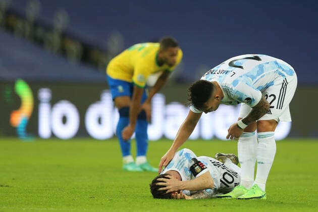 10th July 2021, Est& xe1;dio do Maracan& xe3;, Rio de Janeiro, Brazil. Copa America tournament final, Argentina versus Brazil; Lionel Messi of Argentina, goes down from contact and is checked by Lautaro Mart& xed;nez of Argentina  ActionPlus12304504 HeulerxAndrey