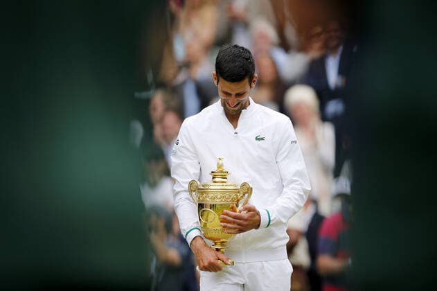 Mandatory Credit: Photo by Shutterstock (12204580ad) Novak Djokovic of Serbia celebrates with the trophy Wimbledon Tennis Championships, Day 13, The All England Lawn Tennis and Croquet Club, London, UK - 11 Jul 2021 Wimbledon Tennis Championships, Day 13, The All England Lawn Tennis and Croquet Club, London, UK - 11 Jul 2021  Copyright: xShutterstockx 12204580ad