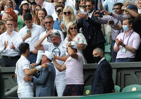 Lawn Tennis - 2021 All England Championships - Men™s Final Sunday - Wimbledon - Novak Djokovic v Matteo Berrettini on Centre Court Novak Djokovic climbs up into the players box to see his coaches 