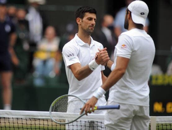 Lawn Tennis - 2021 All England Championships - Men™s Final Sunday - Wimbledon - Novak Djokovic v Matteo Berrettini on Centre Court Novak Djokovic is congratulated by Matteo Berrettini at the net 
