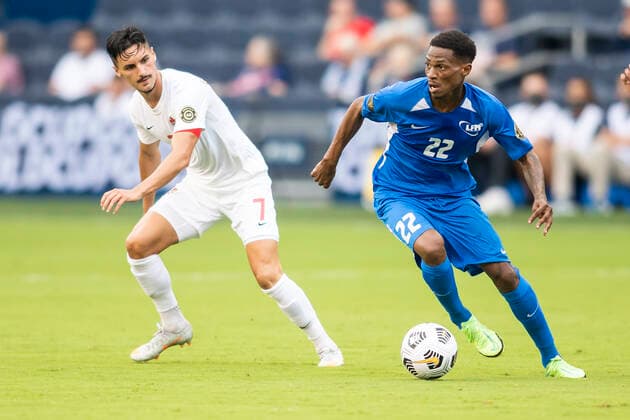 KANSAS CITY, KS - JULY 11: Martinique midfielder Romario Barthelery (22) attempts to push past Canada midfielder Stephen Eustaquio (7) during the CONCACAF Gold Cup match between Canada and Martinique on Sunday, July 11, 2021 at Children™s Mercy park in Kansas City, KS. (Photo by Nick Tre. Smith Icon Sportswire) SOCCER: JUL 11 Concacaf Gold Cup - Canada v Martinique Icon2107110069