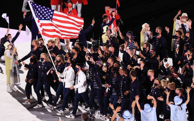 TOKYO, JAPAN â€“ JULY 23, 2021: Basketball player Sue Bird and baseball player Eddy Alvarez (L-R in the middle) of the United States carry a US national flag during the Parade of Nations at the opening ceremony of the Tokyo 2020 Summer Olympic Games, Olympische Spiele, Olympia, OS at the National Stadium. Tokyo was to host the 2020 Summer Olympics from 24 July to 9 August 2020, however because of the COVID-19 pandemic the games have been postponed for a year and are due to take place from 23 July to 8 August 2021. Sergei Bobylev TASS  TS1090DC
