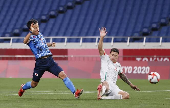 Tokyo Olympics: Football Japan s Takefusa Kubo (L) opens the scoring against Mexico during the first half of their Group A men s football match of the Tokyo Olympics on July 25, 2021, at Saitama Stadium in Saitama, eastern Japan. (SELECTION)  A14AA0000754341P