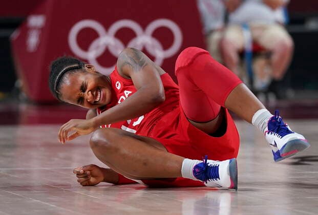 July 26, 2021, Tokyo, Japan: Team Canada shooting guard Shay Colley (13) injures her shoulder in a collision with Team Serbia point guard Yvonne Anderson, not shown, during second half Olympic basketball action at the Tokyo Olympics in Tokyo, Japan on Monday, July 26, 2021. Canada News - July 26, 2021  - ZUMAc35_ 20210726_zaf_c35_019 Copyright: xNathanxDenettex