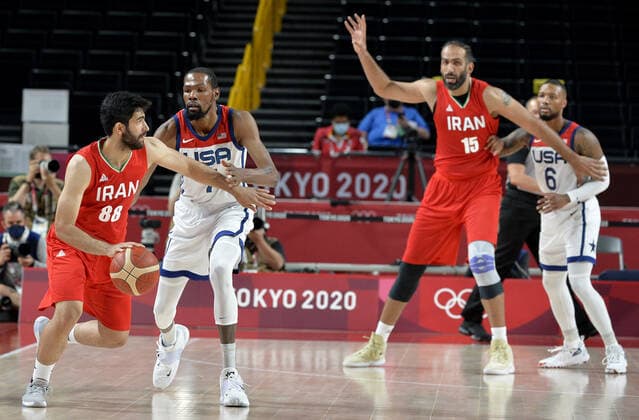 Iran s Behnam Yakhchalidehkordi (L) dribbles around United States Kevin Durant as he looks to teammate Hamed Haddadi (15), guarded by USA s Damian Lillard during a Men s Basketball game at the Tokyo 2020 Olympics, Wednesday, July 28, 2021, in Tokyo, Japan. The USA won easily, 120-66.  OLY20210728813 MIKExTHEILER