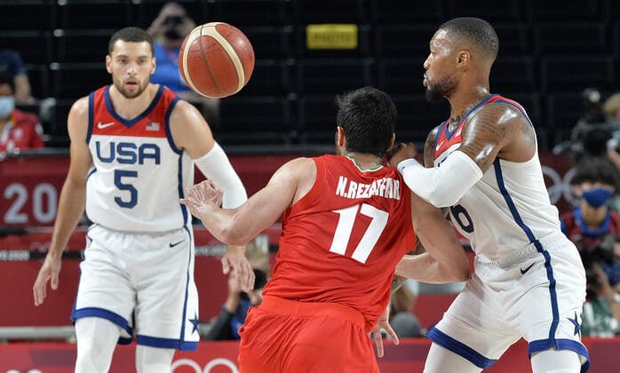 Iran s Navid Rezaeifar (17) battles for the basketball with United States Damian Lillard (R) as Zach Lavine (5) looks on during a Men s Basketball game at the Tokyo 2020 Olympics, Wednesday, July 28, 2021, in Tokyo, Japan. The USA won easily, 120-66.  OLY20210728816 MIKExTHEILER