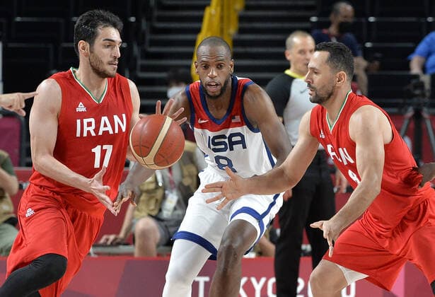 Iran s Saeid Davarpanah (R) passes the ball to teammate Navid Rezaeifar (17)as United States Khris Middleton looks on during a Men s Basketball game at the Tokyo 2020 Olympics, Wednesday, July 28, 2021, in Tokyo, Japan. The USA won easily, 120-66.  OLY20210728817 MIKExTHEILER