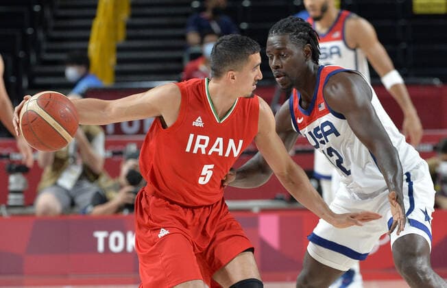 Iran s Pujan Jalalpoor (5) is closely guarded by United States Jrue Holiday during a Men s Basketball game at the Tokyo 2020 Olympics, Wednesday, July 28, 2021, in Tokyo, Japan. The USA won easily, 120-66.  OLY20210728818 MIKExTHEILER