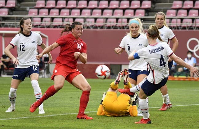 United States Goalie Alyssa Naeher (C) falls on the ground with an ankle injury as teammates (L-r) Tierna Davidson (12) Becky Sauerbrunn play on against Canada s Vanessa Gilles (14) during Women s Soccer semi-final match at the Tokyo 2020 Olympics, Monday, August 2, 2021, in Kashima, Japan.  OLY20210802802 MIKExTHEILER