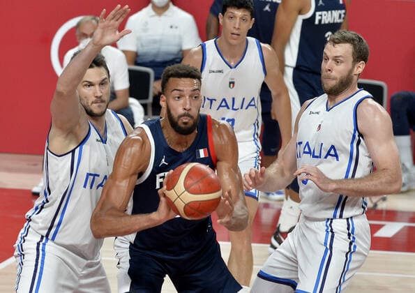 France s Rudy Gobert looks to pass the ball as he is defended by Italy s Danilo Gallinari (L) and Stefano Tonut during the Men s Basketball quarterfinal game at the Tokyo 2020 Olympics on Tuesday, August 3, 2021, in Tokyo, Japan.  OLY20210803820 MIKExTHEILER