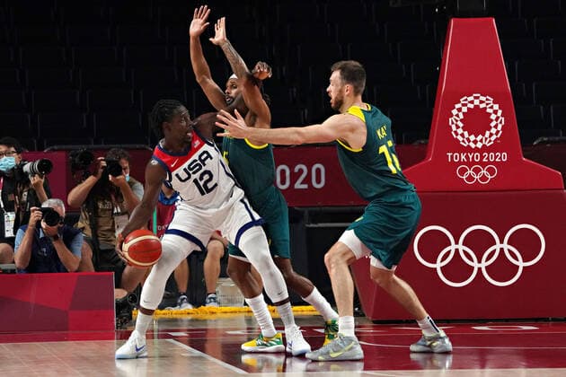 United States guard Jrue Holiday 12, is blocked by Australia power forward Nic Kay 15, and point guard Patty Mills 5, during the Men s Basketball semi-final at the Tokyo Olympic Games, Olympische Spiele, Olympia, OS in Tokyo, Japan, on Thursday, August 5, 2021. The United States beat Australia 97-78. OLY20210805207 RICHARDxELLIS