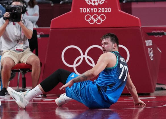 (210805) -- SAITAMA, Aug. 5, 2021 -- Luka Doncic of Slovenia falls off during the men s basketball semifinal between France and Slovenia at Tokyo 2020 Olympic Games, Olympische Spiele, Olympia, OS in Saitama, Japan, Aug. 5, 2021. ) (TOKYO2020)JAPAN-SAITAMA-OLY-BASKETBALL-MEN S SEMIFINAL-FRA VS SLO MengxYongmin 