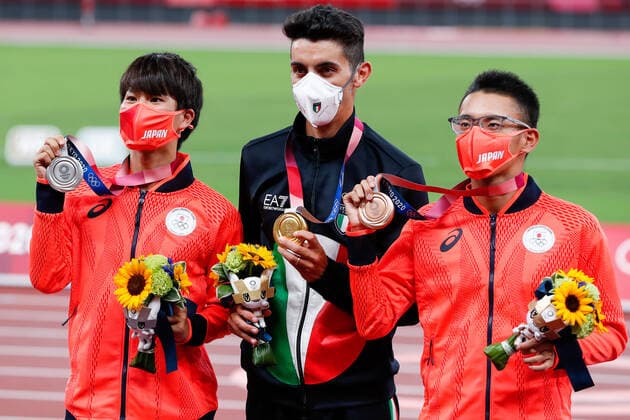 From left Men s 20km silver medalist Koki Ikeda of Japan, gold medalist Massimo Stano of Italy, and bronze medalist Toshikazu Yamanishi of Japan pose for a photo during the medal ceremony at Olympic Stadium at the 2020 Summer Olympics in Tokyo, Japan on Friday, August 6, 2021.  OLY20210806403 TasosxKatopodis