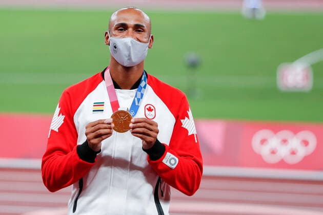 Men s decathlon gold medalist Damian Warner of Canada shows off his medal during the medal ceremony at Olympic Stadium at the 2020 Summer Olympics in Tokyo, Japan on Friday, August 6, 2021. Damian Warner of Canada took gold with 9018 points, Kevin Mayer of France took silver with 8726 points and Ashley Moloney of Australia took bronze with 8649 points.  OLY20210806410 TasosxKatopodis