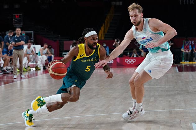 Australia point guard Patty Mills (5) slips past Slovenia shooting guard Jaka Blazic (11), as he drives to the basket during the Men s Basketball bronze medal game at the Tokyo Olympic Games, Olympische Spiele, Olympia, OS in Tokyo, Japan, on Saturday, August 7, 2021.  OLY20210807254 RICHARDxELLIS