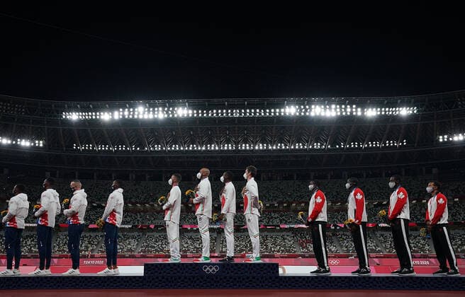 (210807) -- TOKYO, Aug. 7, 2021 -- Team members of Italy (C), the Great Britain (L) and Canada react during the awarding ceremony of the Men s 4x100m Relay at the Tokyo 2020 Olympic Games, Olympische Spiele, Olympia, OS in Tokyo, Japan, Aug. 7, 2021. ) (TOKYO2020)JAPAN-TOKYO-OLY-ATHLETICS-MEN S 4x100M RELAY-AWARDING CEREMONY LuixSiuxWai 