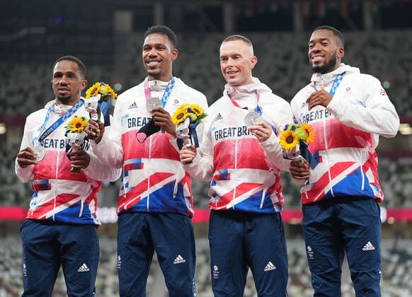 (210807) -- TOKYO, Aug. 7, 2021 -- Team members of the Great Britain react during the awarding ceremony of the Men s 4x100m Relay at the Tokyo 2020 Olympic Games, Olympische Spiele, Olympia, OS in Tokyo, Japan, Aug. 7, 2021. ) (TOKYO2020)JAPAN-TOKYO-OLY-ATHLETICS-MEN S 4x100M RELAY-AWARDING CEREMONY LuixSiuxWai 