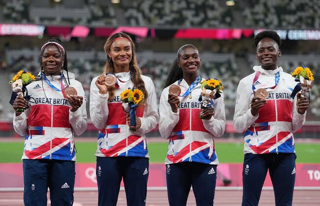 (210807) -- TOKYO, Aug. 7, 2021 -- Team members of Jamaica react during the awarding ceremony of the Women s 4x100m Relay at the Tokyo 2020 Olympic Games, Olympische Spiele, Olympia, OS in Tokyo, Japan, Aug. 7, 2021. ) (TOKYO2020)JAPAN-TOKYO-OLY-ATHLETICS-WOMEN S 4x100M RELAY-AWARDING CEREMONY LuixSiuxWai 