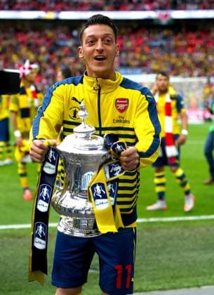 Mandatory Credit: Photo by Kieran Mcmanus BPI Shutterstock (4805657bo) Mesut Ozil of Arsenal celebrates with the 2015 FA Cup trophy The FA Cup 2014 15 Final Arsenal v Aston Villa Wembley Stadium, Wembley, London, United Kingdom - 30 May 2015 EDITORIAL USE ONLY No use with unauthorised audio, video, data, fixture lists (outside the EU), club league logos or live services. Online in-match use limited to 45 images (+15 in extra time). No use to emulate moving images. No use in betting, games or single club league player publications services. The FA Cup 2014 15 Final Arsenal v Aston Villa Wembley Stadium, Wembley, London, United Kingdom - 30 May 2015 EDITORIAL USE ONLY No use with unauthorised audio, video, data, fixture lists (outside the EU), club league logos or live services. Online in-match use limited to 45 images (+15 in extra time). No use to emulate moving images. No use in betting, games or  Copyright: xKieranxMcmanus BPI Shutterstockx 4805657bo