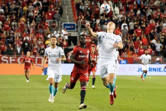 August 14, 2021, Toronto, Ontario, Canada: Kemar Lawrence (92) and Adam Buksa (9) in action during the MLS, Fussball Herren, USA game between between Toronto FC and New England Revolution The game ended 1-2 Toronto Canada - ZUMAm154 20210814_zap_m154_017 Copyright: xAngelxMarchinix