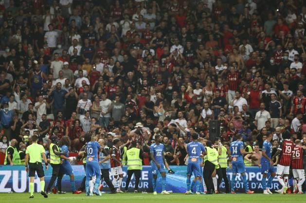 Nice, France, 22nd August 2021. Fans spill onto the pitch to interrupt the game after the Dimitri Payet of Olympique De Marseille threw an object back into the crown that was intially thrown in his direction during the Lique 1 match at Allianz Riviera Stadium, Nice. Picture credit should read: Jonathan Moscrop Sportimage EDITORIAL USE ONLY. No use with unauthorised audio, video, data, fixture lists, club league logos or live services. Online in-match use limited to 120 images, no video emulation. No use in betting, games or single club league player publications. SPI-1148-0018