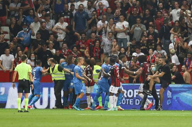 Nice, France, 22nd August 2021. Fans spill onto the pitch to interrupt the game after the Dimitri Payet of Olympique De Marseille threw an object back into the crown that was intially thrown in his direction during the Lique 1 match at Allianz Riviera Stadium, Nice. Picture credit should read: Jonathan Moscrop Sportimage EDITORIAL USE ONLY. No use with unauthorised audio, video, data, fixture lists, club league logos or live services. Online in-match use limited to 120 images, no video emulation. No use in betting, games or single club league player publications. SPI-1148-0023
