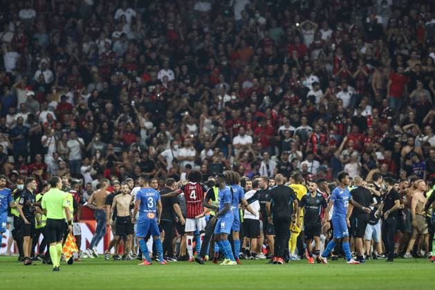 Nice, France, 22nd August 2021. Fans spill onto the pitch to interrupt the game after the Dimitri Payet of Olympique De Marseille threw an object back into the crown that was intially thrown in his direction during the Lique 1 match at Allianz Riviera Stadium, Nice. Picture credit should read: Jonathan Moscrop Sportimage EDITORIAL USE ONLY. No use with unauthorised audio, video, data, fixture lists, club league logos or live services. Online in-match use limited to 120 images, no video emulation. No use in betting, games or single club league player publications. SPI-1148-0024