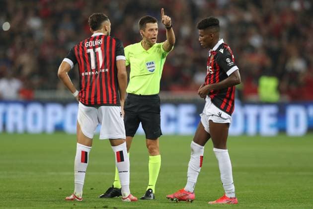 Nice, France, 22nd August 2021. The referee Benoit Bastien orders Hicham Boudaoui of OGC Nice to take his distance as he discusses with his team mate Amine Gouiri during the Lique 1 match at Allianz Riviera Stadium, Nice. Picture credit should read: Jonathan Moscrop Sportimage EDITORIAL USE ONLY. No use with unauthorised audio, video, data, fixture lists, club league logos or live services. Online in-match use limited to 120 images, no video emulation. No use in betting, games or single club league player publications. SPI-1148-0072