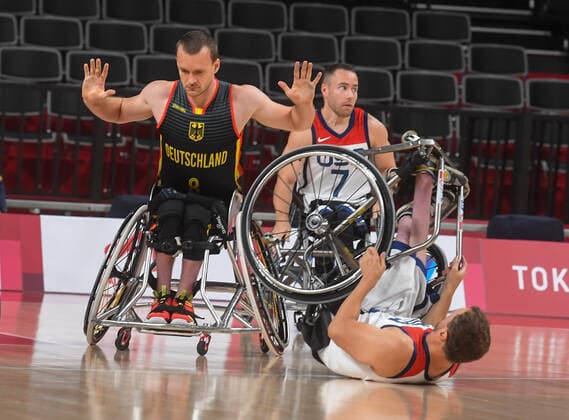 6633150 26.08.2021 Germany s Andre Bienek, left, reacts during the men s wheelchair basketball Group B match between the United States and Germany at the Tokyo 2020 Paralympic Games at Ariake Arena in Tokyo, Japan. Ilya Pitalev Sputnik Japan Paralympics 2020 Wheelchair Basketball Men USA - Germany  601295a2b2943f7