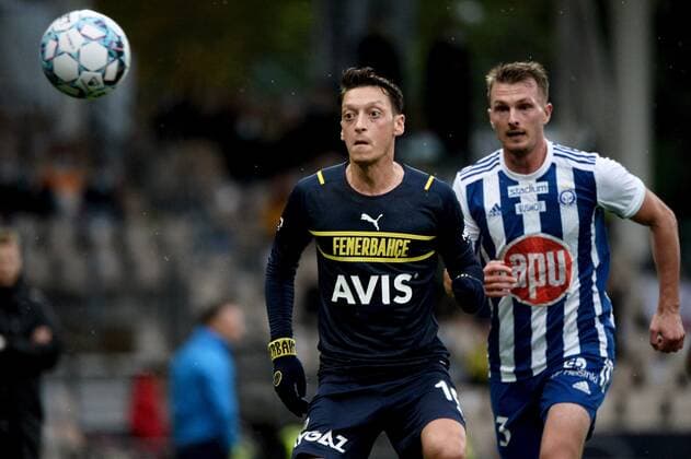 Mesut Özil (L) of Fenerbahce and Janne Saksela of HJK during the football UEFA Europa League play-off match between HJK and Fenerbahce in Helsinki, Finland on August 26, 2021. Helsinki Finland LKFTVX20210826192607BKVW  Copyright: xMikkoxStigx