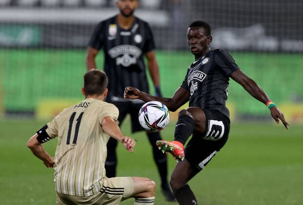 SOCCER - UEFA EL, Sturm vs Mura GRAZ,AUSTRIA,26.AUG.21 - SOCCER - UEFA Europa League play off, SK Sturm Graz vs NS Mura. Image shows Ziga Kous (Mura) and Kelvin Yeboah (Sturm).  GEPAxpictures xHansxOberlaender