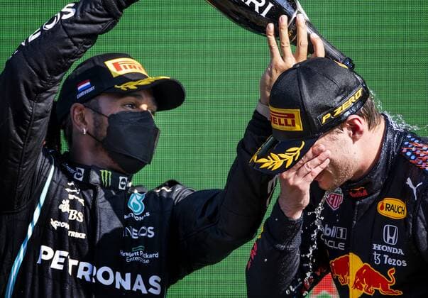 ZANDVOORT - Max Verstappen (Red Bull Racing) celebrates winning the Dutch Grand Prix at the Zandvoort circuit together with Lewis Hamilton (Mercedes). KOEN VAN WEEL Grand Prix xVIxANPxSportx xxANPxIVx
