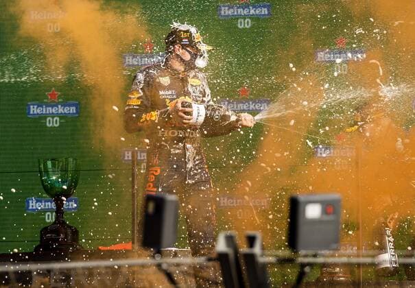 ZANDVOORT - Max Verstappen (Red Bull) sprays champagne on the podium after winning the Dutch Grand Prix at the Zandvoort circuit. REMKO DE WAAL Grand Prix xVIxANPxSportx xxANPxIVx