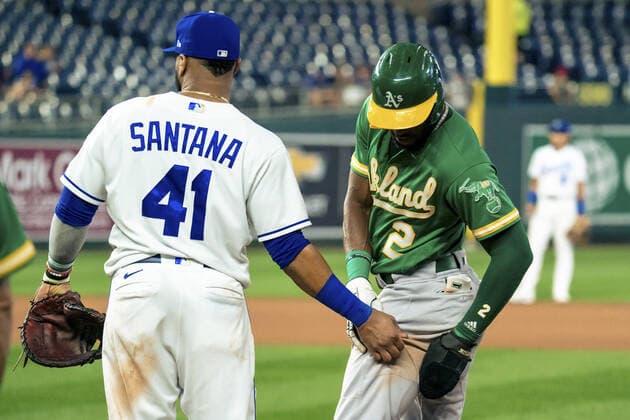 Kansas City Royals first baseman Carlos Santana (41) and Oakland Athletics center fielder Starling Marte (2) poke fun at each other at first base during the fifth inning at Kauffman Stadium in Kansas City, Missouri on Tuesday, September 14, 2021.  KCP20210914114 KYLExRIVAS
