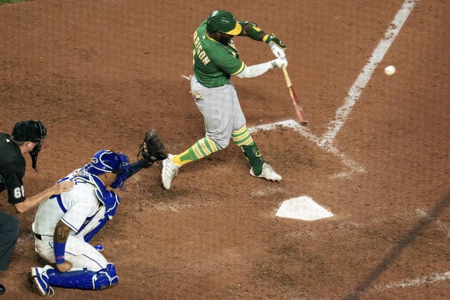Oakland Athletics second baseman Josh Harrison (1) connects with a Kansas City Royals pitch in the fifth inning at Kauffman Stadium in Kansas City, Missouri on Tuesday, September 14, 2021.  KCP20210914117 KYLExRIVAS